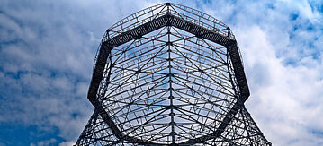 Gerüst eines AKW Kühlturms vor blauen Himmel mit Wolken