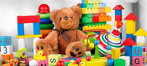 Teddy, bunte Bausteine und gelbe Gummienten 