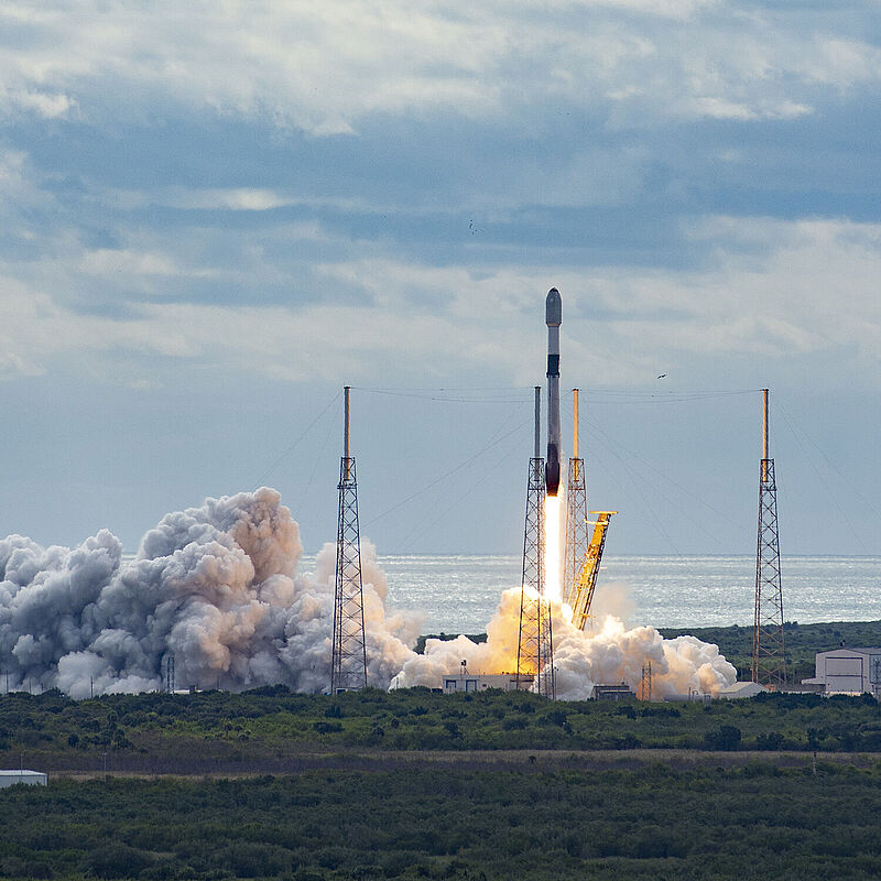 Eine Rakete startet von einem Raumfahrthafen.