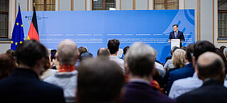 Blick in den Saal mit Carsten Schneider am Rednerpult