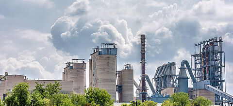 Fabrikanlage mit Schornsteinen stößt Rauch aus
