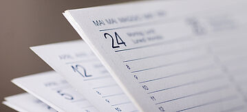 Nahaufnahme von aufgefächerten Tischkalenderblättern