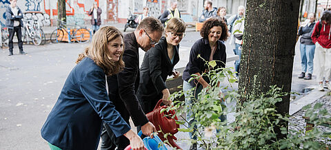 Carsten Schneider gießt einen Baum im Rahmen einer Bewässerungsaktion
