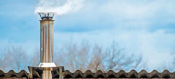 Rauchender Schornstein auf dem Dach