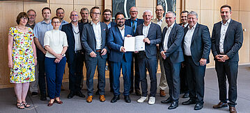 Gruppenbild mit Christian Kühn und Urkunde