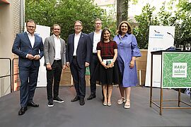 Bundesminister Carsten Schneider, Ex-Fußballnationalspieler Philipp Lahm, NABU-Präsident Jörg-Andreas Krüger, NABU-Bundesgeschäftsführer Ingo Immermann, Moderatorin Nadine Kreutzer und NABU-Bundesgeschäftsführerin Susanne Baumann (von links nach rechts)